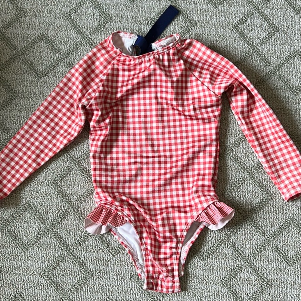 Gently worn girls Minnow long sleeve rash guard one piece in red gingham, 2T.